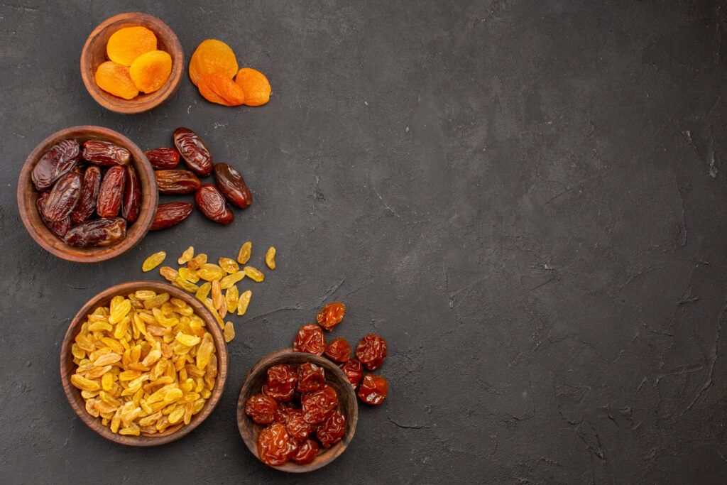 Dates and White Raisins in wooden bowls